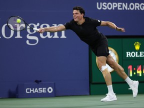Milos Raonic of Canada returns a shot against Stefanos Tsitsipas of Greece during their Men's Singles First Round match on Day One of the 2023 U.S. Open at the USTA Billie Jean King National Tennis Center on Aug. 28, 2023 in the Flushing neighbourhood of the Queens borough of New York City.