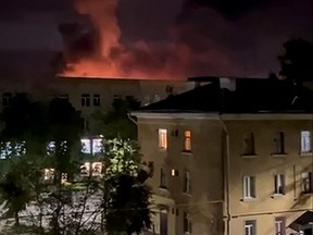 In this grab taken from a handout video posted on the Telegram account of Mikhail Vedernikov, the governor of Russia's Pskov region, on Aug. 30, 2023, an explosion lights up the sky as the Russian military repell a drone attack on an airport in the northwestern city of Pskov