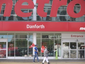 Striking Metro grocery store workers of Unifor Local 414 hold picket lines outside the Shoppers World store at Danforth Ave. and Victoria Park Ave. on Tuesday August 1, 2023.