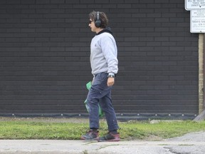 A woman who tenants and neighbours identified as Carla walks to the front of the building on Wednesday August 2, 2023. Jack Boland/Toronto Sun
