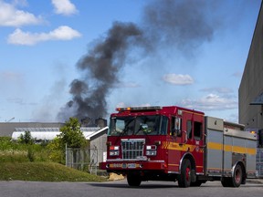 Toronto firefighters at the scene of an industrial fire on Vulcan St., near Martin Grove and Belfield Rds., in Toronto on Friday, August 11, 2023.