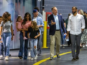 Jose Bautista arrives with his family and Toronto Blue Jays president and CEO Mark Shapiro.