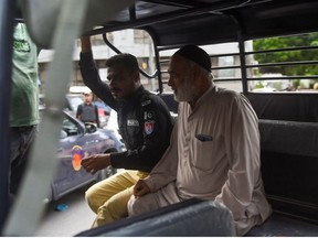 A police personnel arrests a supporter of Pakistan's former prime minister Imran Khan