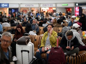 Passengers wait at Stansted Airport