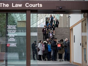Members of the media and public line up to enter a courtroom