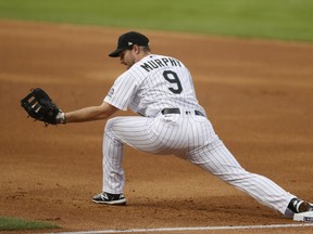 FILE - Colorado Rockies first baseman Daniel Murphy catches a throw during the first inning of the team's baseball game against the San Diego Padres on July 31, 2020, in Denver. Murphy's surprising comeback bid ended with the three-time All-Star infielder going on the voluntarily retired list after playing 38 games with the Los Angeles Angels' Triple-A team.