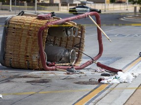 The basket of a hot air balloon lies on the pavement after a crash landing in Albuquerque, N.M., Saturday, June 26, 2021.
