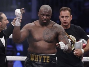 Dillian Whyte of Britain celebrates winning a heavyweight undercard boxing match against Mariusz Wach of Poland at the Diriyah Arena, in Riyadh, Saudi Arabia, Saturday, Dec. 7, 2019. Dillian Whyte's heavyweight rematch against Anthony Joshua was canceled after Whyte returned "adverse analytical findings" on a doping test, Matchroom Boxing said Saturday. The bout had been scheduled for Aug. 12 at London's O2 Arena.