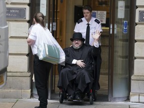 Nicholas Rossi from he U.S. waves as he leaves the Edinburgh Sheriff and Justice of the Peace Court in Edinburgh, Scotland, Wednesday, July 12, 2023.
