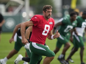 New York Jets quarterback Aaron Rodgers warms-up during a joint NFL football practice with the Tampa Bay Buccaneers, Wednesday, Aug. 16, 2023, in Florham Park, N.J.