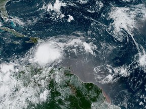 In this Monday, Aug. 21, 2023, 9:03am ET satellite image provided by the National Oceanic and Atmospheric Administration, Tropical Storm Franklin moves south of Hispaniola island.
