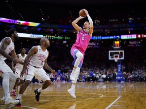 FILE - Washington Wizards' Kristaps Porzingis shoots against the Philadelphia 76ers during an NBA basketball game March 12, 2023, in Philadelphia. Porzingis, whom the Boston Celtics acquired in a trade this offseason, will not play for Latvia in the FIBA World Cup because of plantar fasciitis, a foot problem that has lingered. Porzingis announced on X, the social-media platform previously known as Twitter, that he made the decision after an MRI in consultation with the Celtics and Latvian coaching and medical staffs.