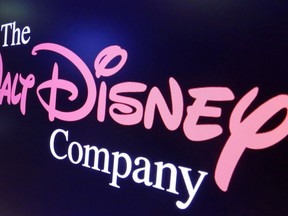 FILE - The Walt Disney Co. logo appears on a screen above the floor of the New York Stock Exchange on Aug. 7, 2017. Disney reported narrower losses on its Disney+ streaming platform in the quarter ended July 1, 2023, and boosted revenues, but also shed Disney+ subscribers for the second quarter in a row.