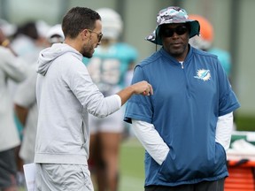 Miami Dolphins head coach Mike McDaniel, left, talks with general manager Chris Grier, right, during practice at the NFL football team's training facility, Tuesday, Aug. 1, 2023, in Miami Gardens, Fla.