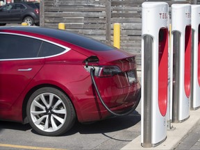 A Tesla car is being charged at the Tesla Supercharger station at King's Cross shopping mall in Kingston, Ont., on Tuesday, July 7, 2020.