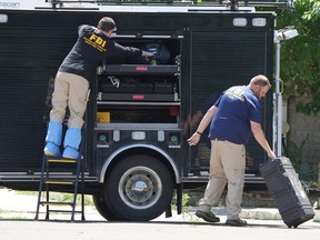 FBI officials unload equipment