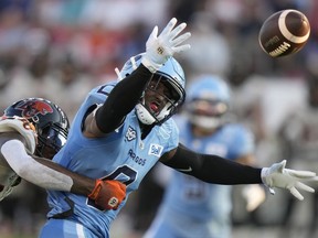 Toronto Argonauts defensive back Robertson Daniel (0) breaks up a pass intended for BC Lions wide receiver Dominique Rhymes, left, allowing a teammate to make an interception during first half CFL action in Toronto on Monday, July 3, 2023. The Argonauts return from their final bye week of the season Friday night to host the Calgary Stampeders at BMO Field.