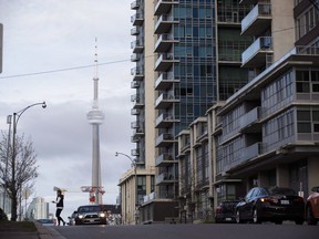 The CN Tower can be seen behind condos in Toronto's Liberty Village community on Tuesday, April 25, 2017.