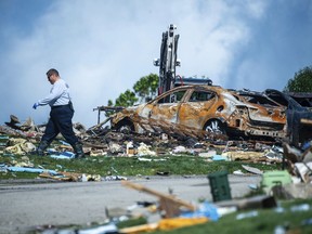 An investigator walks through the debris from a home explosion
