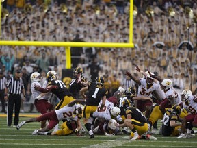 FILE - Iowa place kicker Aaron Blom (1) misses a field goal at the end of an NCAA college football game against Iowa State, Saturday, Sept. 10, 2022, in Iowa City, Iowa. Iowa State won 10-7. A former walk-on kicker at the University of Iowa was charged Wednesday, Aug. 2, 2023, in connection with wagering on Hawkeyes sports events -- one day after Iowa State quarterback Hunter Dekkers was accused of committing the same offense. The criminal complaint filed in Johnson County said Aaron Blom, who was on the Iowa roster from 2020-22, tampered with records related to an Iowa Criminal Division investigation into sports gambling.