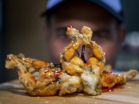Marco Zambri poses with Korean Fried Frog Legs at the CNE media preview day in Toronto on Wednesday, Aug. 16, 2023. ERNEST DOROSZUK/TORONTO SUN