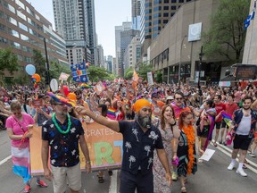 NDP Leader Jagmeet Singh and Rosemont-La Petite-Patrie MP Alexandre Boulerice, left, walk in the Montreal Pride Parade, along Rene Levesque Boulevard, in Montreal, Sunday, Aug. 13, 2023.