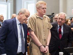 FILE - Alex Murdaugh speaks with his legal team before he is sentenced to two consecutive life sentences for the murder of his wife and son by Judge Clifton Newman at the Colleton County Courthouse on Friday, March 3, 2023 in in Walterboro, S.C. Murdaugh's lawyers have filed court papers that he plans to plead guilty in federal court to charges he stole money from clients.