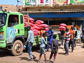 Bags of rice are offloaded from a truck at Niamey's main market on Aug. 8, 2023.