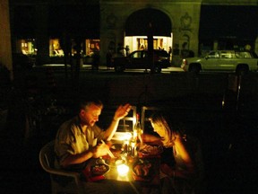 A couple enjoys a candlelight dinner at a downtown Toronto restaurant Thursday, August 14, 2003, during a major power failure. Twenty years ago, some 50 million North Americans suddenly lost their power and learned to briefly live without light, television and all the other energy-sucking conveniences that have become staples of modern life.