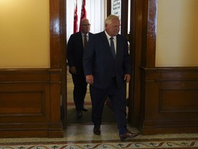 Ontario Premier Doug Ford, right, followed by Minister of Municipal Affairs and Housing Steve Clark leave a press conference following the release of the Auditor General's Special Report on Changes to the Greenbelt, at Queens Park, in Toronto, Wednesday, Aug. 9, 2023.