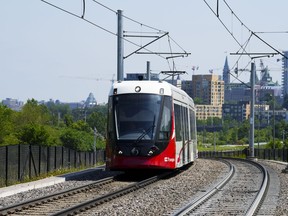 An Ottawa Light Rail Transit (OLRT) train travels along the tracks in Ottawa on Wednesday, June 22, 2022.