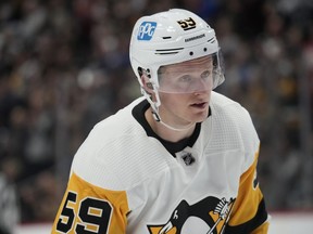 FILE - Pittsburgh Penguins left wing Jake Guentzel (59) in the second period of an NHL hockey game Wednesday, March 22, 2023, in Denver. Guentzel underwent right ankle surgery on Wednesday, Aug. 2, 2023, and will miss at least three months.