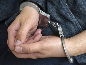 The hands of a young criminal in handcuffs