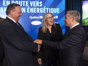 Lisa Drake, centre, vice-president of EV Industrialization for Ford Model e, speaks with Quebec Premier François Legault, left, and Minister of Innovation, Science and Industry François-Philippe Champagne following a press conference to announce the construction of a new Ford manufacturing plant in Becancour, Que., Thursday, Aug.17, 2023.