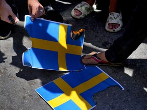 Hezbollah supporters trample representations of the Swedish flag