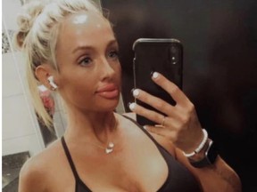 Pretty blonde woman in workout wear taking selfie