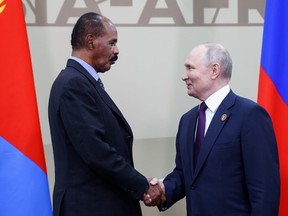 Russian President Vladimir Putin, right, and President of the State of Eritrea Isaias Afwerki shake hands during their meeting on the sideline on the sideline of the Russia Africa Summit in St. Petersburg, Russia, Friday, July 28, 2023.