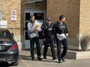 Travis Patron, left, is seen leaving the courthouse