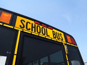 A school bus sits at a service yard