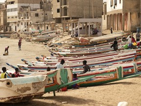 Children play on fishing boats