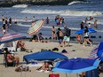 People enjoy the water at Rockaway Beach