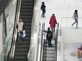 People make their way through a shopping mall in Montreal, Saturday, December 5, 2020. Less than half of Canadians believe retail stores are implementing the right amount of security measures to prevent shoplifting but the majority say they would feel safe working in one, a new Leger poll found.