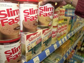 A customer selects a can of Slim Fast