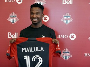 Newly signed Toronto F.C. forward Cassius Mailula, of South Africa, shows off his jersey at the team's training facility in Toronto, Friday, Aug. 18, 2023.