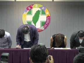 In this image made from video provided by the Democratic Progressive Party, Hsu Li-ming, Secretary general of Democratic Progressive Party, second left, leads other members to bow at a news conference offering apology to victims who say they were sexually harassed and the public in Taipei, Taiwan, on June 2, 2023. Taiwan amended three laws governing sexual harassment on Monday, July 31 in a special session of the legislature, after a wave of #MeToo accusations hit the island in June. (Democratic Progressive Party via AP, File)