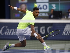 Felix Auger-Aliassime of Canada returns a ball to Max Purcell of Australia during National Bank Open tennis in Toronto, Tuesday, Aug. 8, 2023.