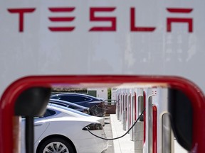 Tesla vehicles charge at a station in Emeryville, Calif., Aug. 10, 2022.