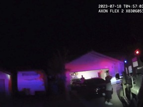 unidentified man and woman are seen as SWAT officers raided a home in Henderson, Nev.