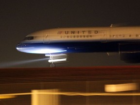 United Airlines jet passes near the main terminal