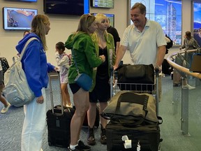 Matthew Taylor (right) and family members return from Maui to Vancouver International Airport on Friday, Aug. 11, 2023.